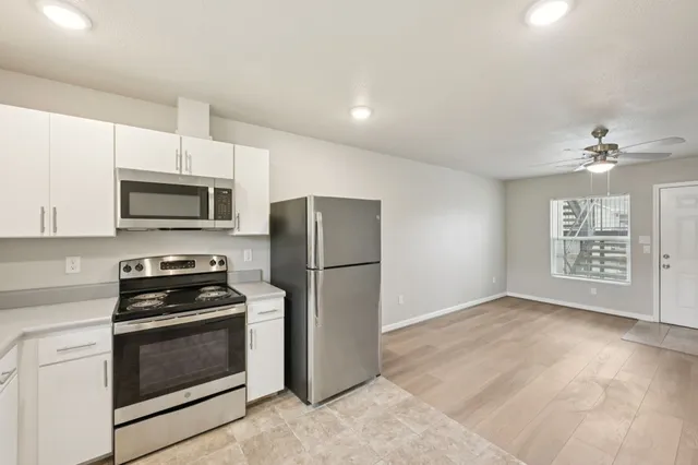 a kitchen with a refrigerator stove and microwave