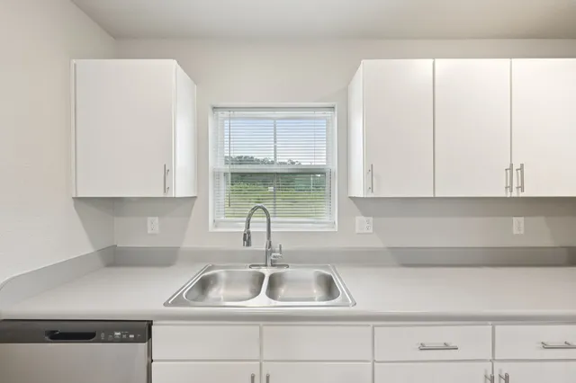 a kitchen with a sink and cabinets