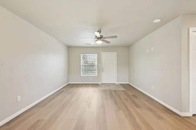 wooden floor in an empty room with a window