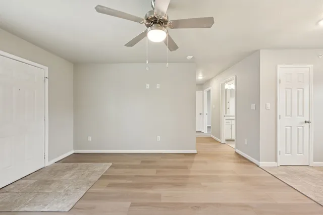 an empty room with fan and a ceiling fan