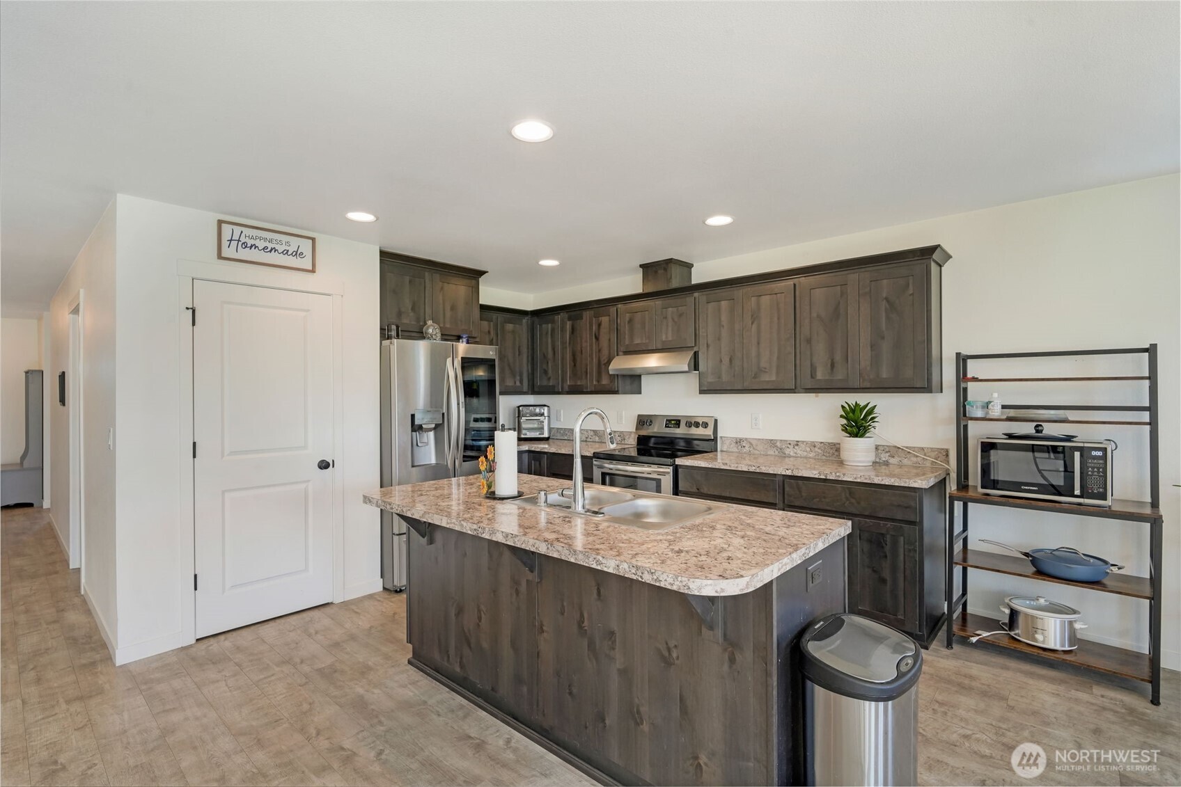602 Cardinal Avenue Winlock, WA 98596 - Photo 12 of 24 a kitchen with kitchen island a sink stove and refrigerator