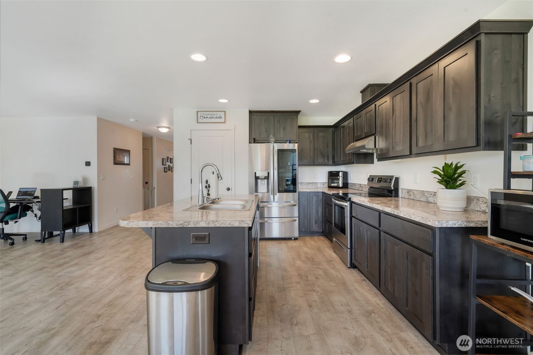 602 Cardinal Avenue Winlock, WA 98596 - Photo 13 of 24 a kitchen with kitchen island granite countertop a sink appliances cabinets and a counter top space