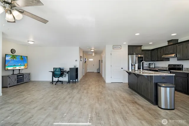 a kitchen with stainless steel appliances a refrigerator and a stove top oven