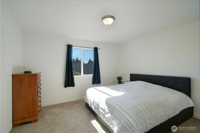 a bedroom with a bed and mirror