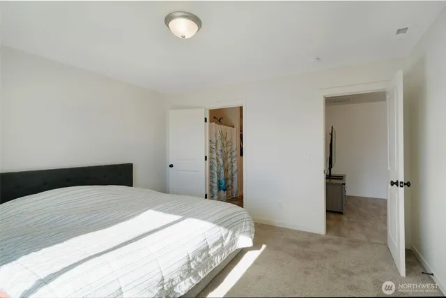 a bedroom with a bed and a table