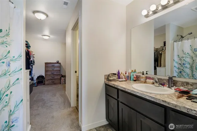 a en suite bathroom with a sink double vanity and a mirror