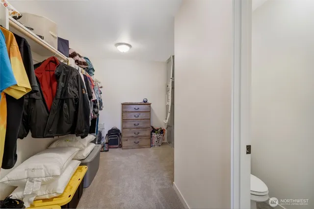 a view of walk in closet with clothes and shoes