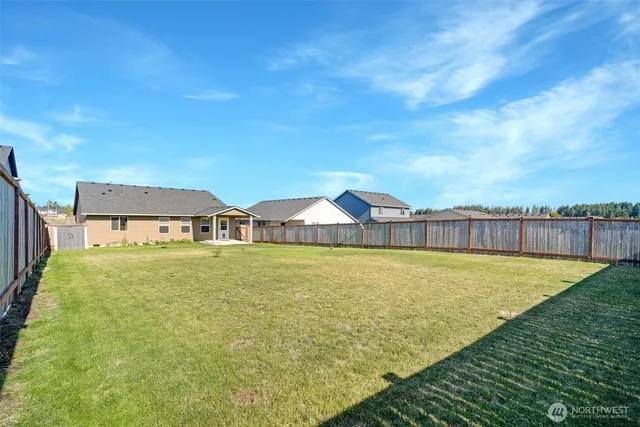 an aerial view of a house with lake view and a yard