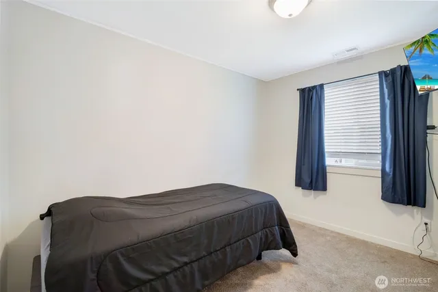 a bedroom with a bed and a window