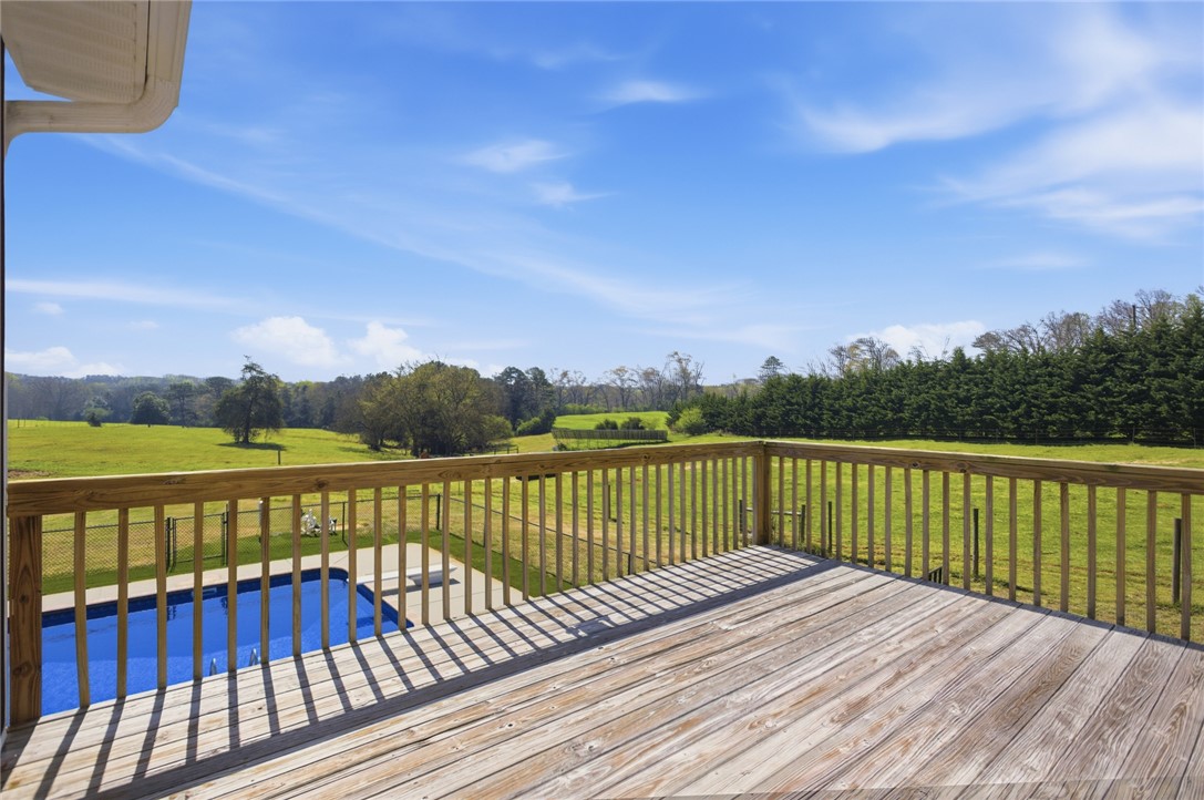 426 Oak Creek Road Seneca, SC 29678 - Photo 10 of 50 This spacious wooden deck offers expansive views of green fields and a refreshing private pool.