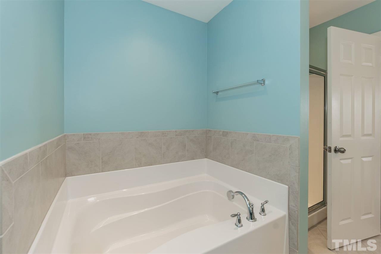 943 Consortium Drive Raleigh, NC 27603 - Photo 22 of 29 a bathroom with a bathtub