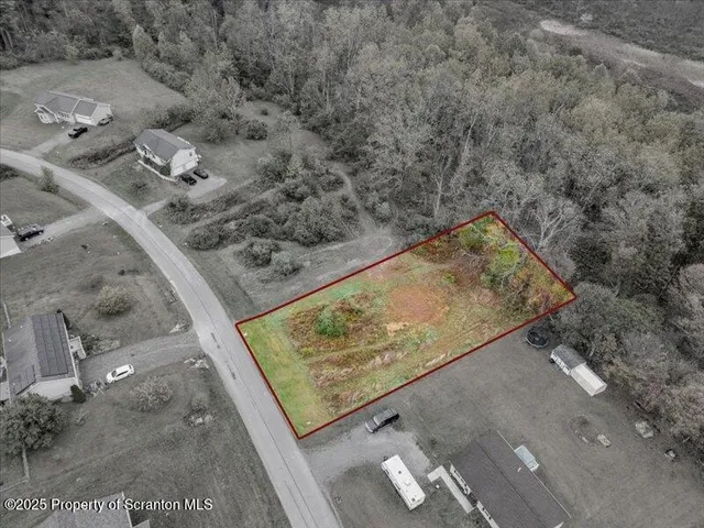 a view of a dry yard with swimming pool