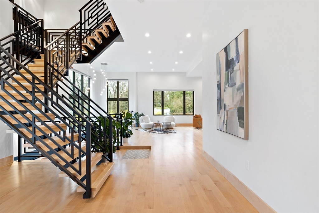 71 Grove Street Brookline, MA 02467 - Photo 16 of 42 a living room with furniture and a chandelier