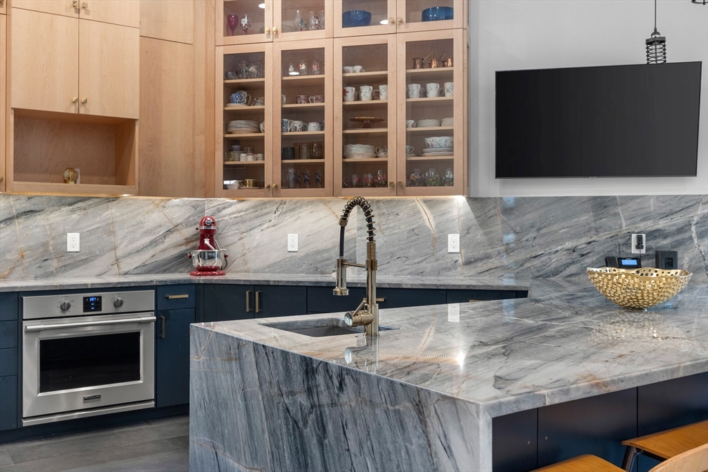 71 Grove Street Brookline, MA 02467 - Photo 20 of 42 a kitchen with granite countertop a sink and a stove