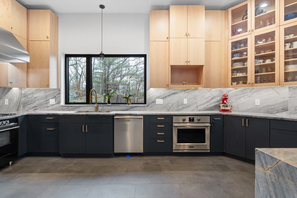 71 Grove Street Brookline, MA 02467 - Photo 21 of 42 a kitchen with granite countertop a stove and a sink
