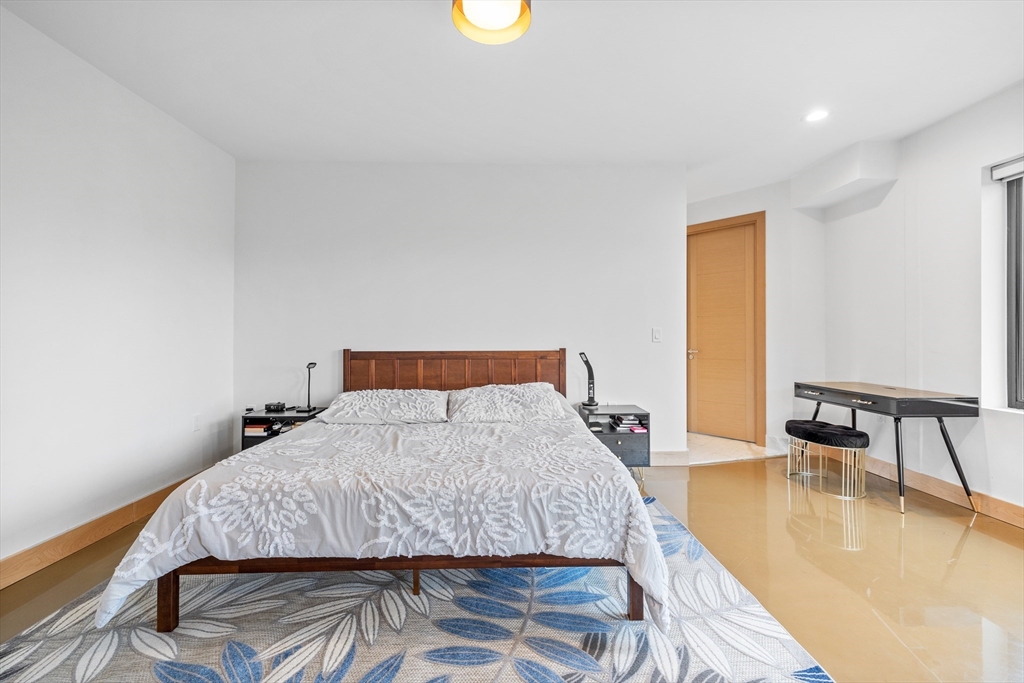 71 Grove Street Brookline, MA 02467 - Photo 24 of 42 a bedroom with a bed and a night stand