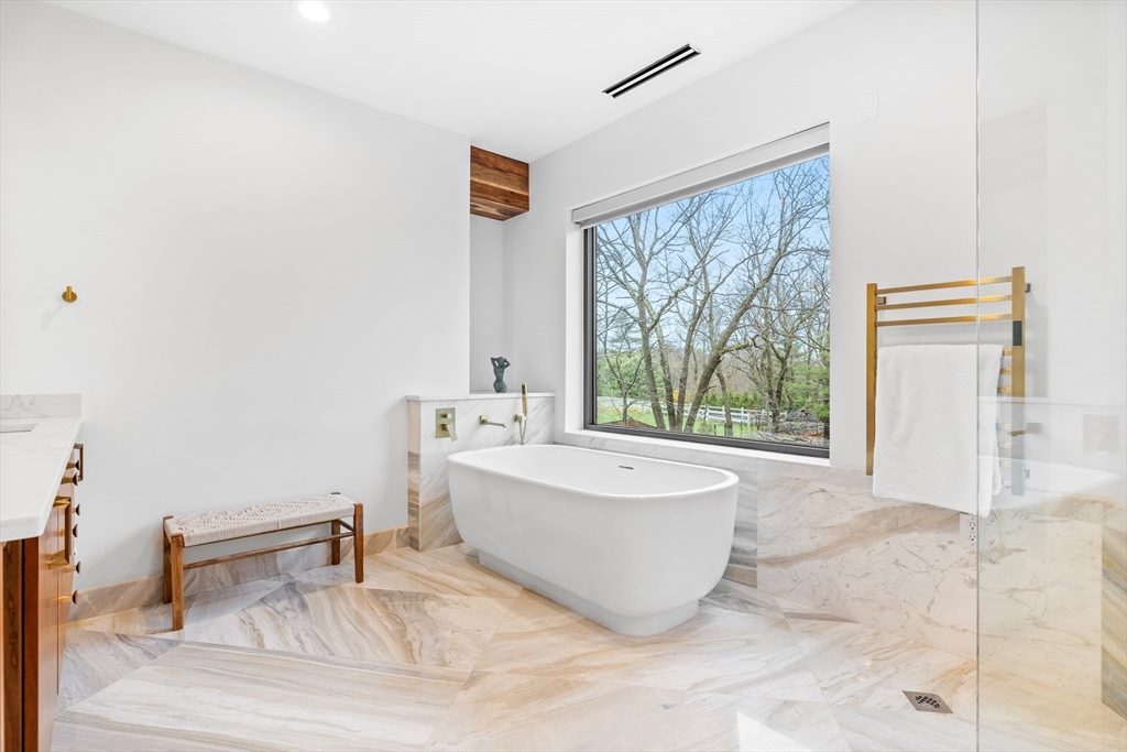 71 Grove Street Brookline, MA 02467 - Photo 25 of 42 a spacious bathroom with a bathtub and next to a window
