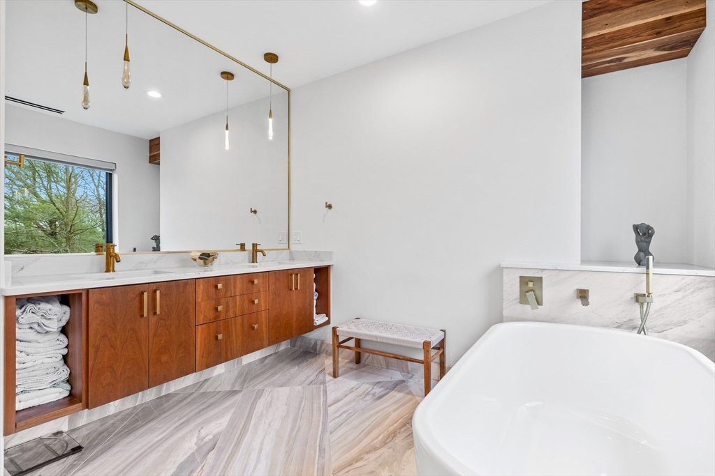 71 Grove Street Brookline, MA 02467 - Photo 29 of 42 a bathroom with a sink and a mirror