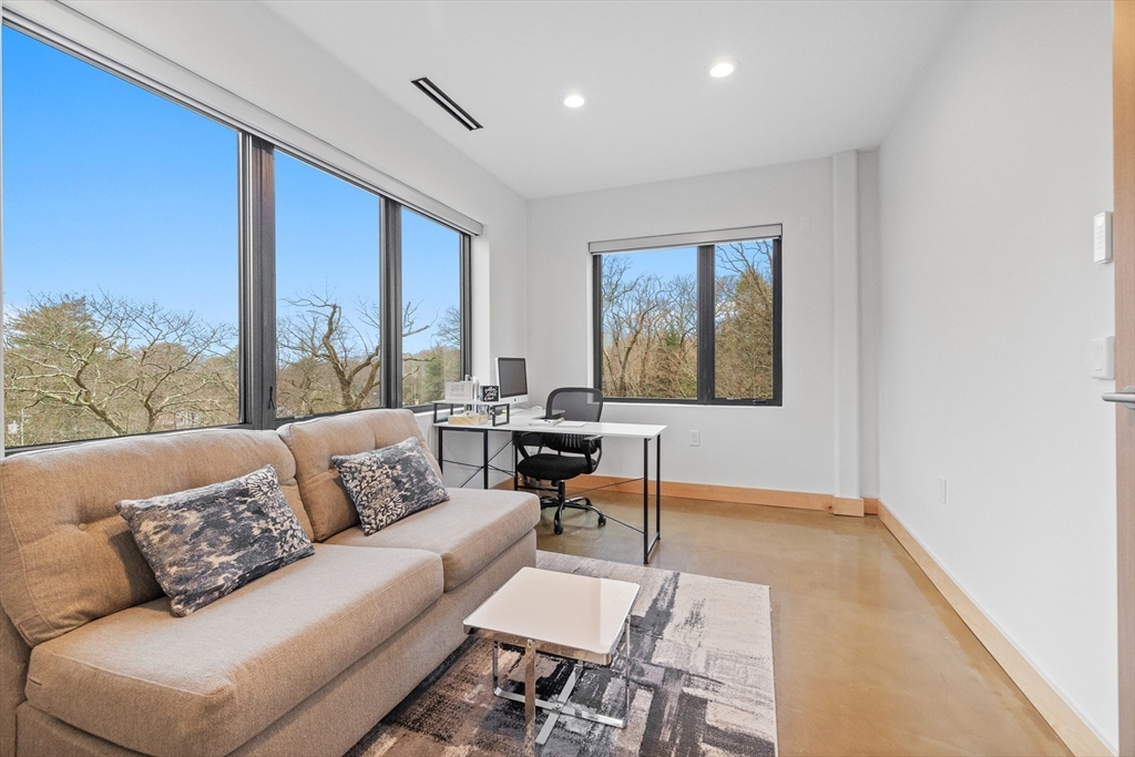 71 Grove Street Brookline, MA 02467 - Photo 30 of 42 a living room with furniture and a window
