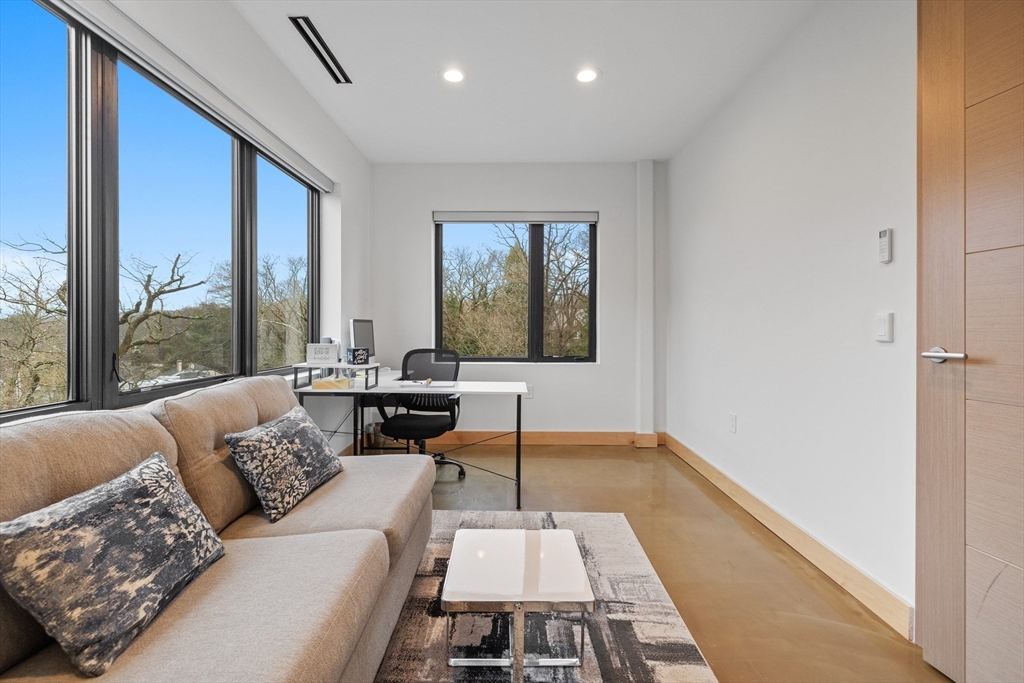 71 Grove Street Brookline, MA 02467 - Photo 31 of 42 a living room with a couch and a table