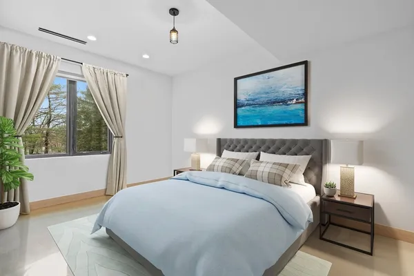 a bedroom with a large bed and a painting on the wall