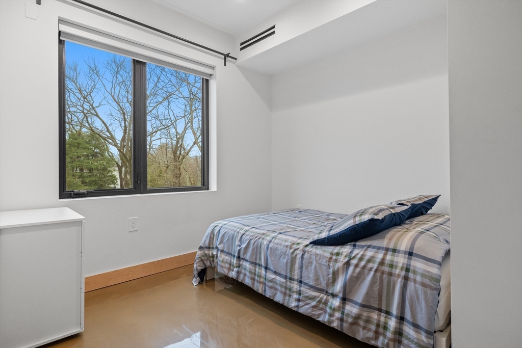 71 Grove Street Brookline, MA 02467 - Photo 34 of 42 a bedroom with a bed and a window