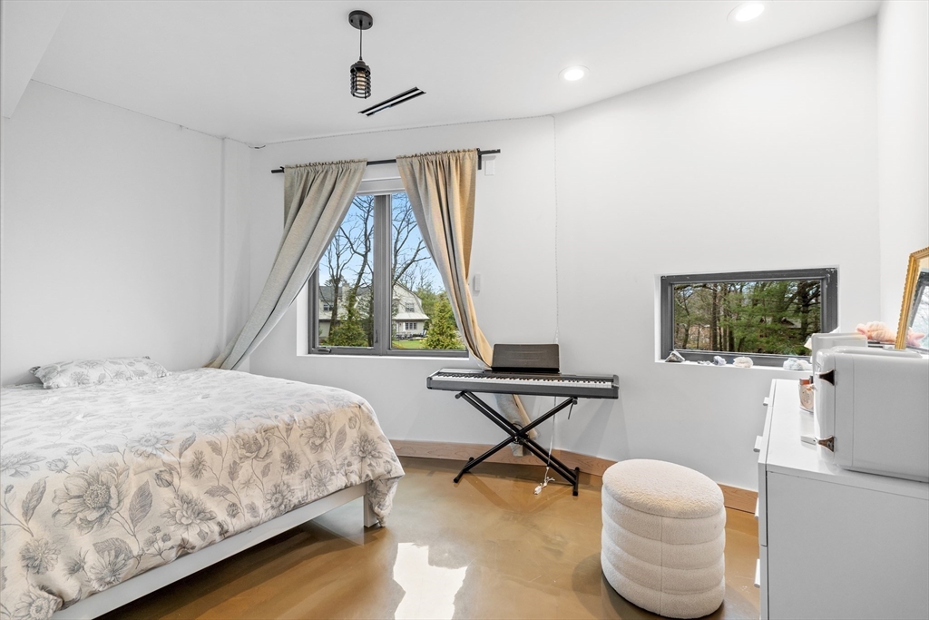 71 Grove Street Brookline, MA 02467 - Photo 35 of 42 a bedroom with a bed and a window