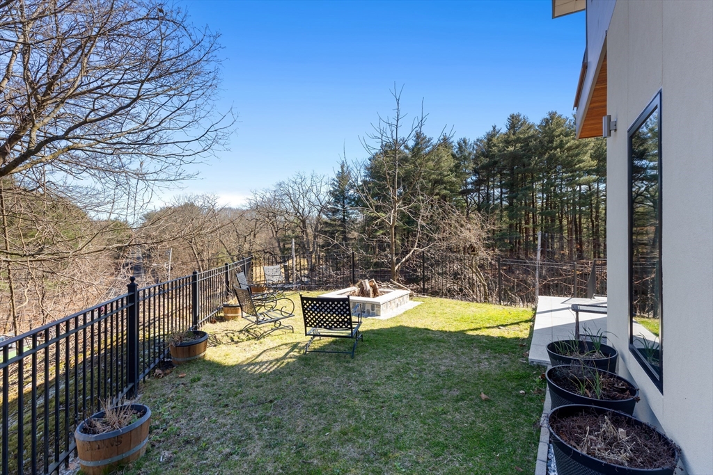 71 Grove Street Brookline, MA 02467 - Photo 42 of 42 a backyard of a house with table and chairs