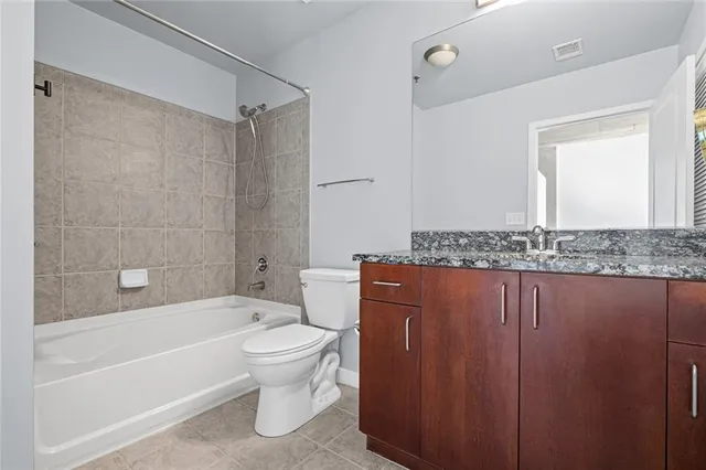 a view of a patio with couches and table and chairs and potted plants