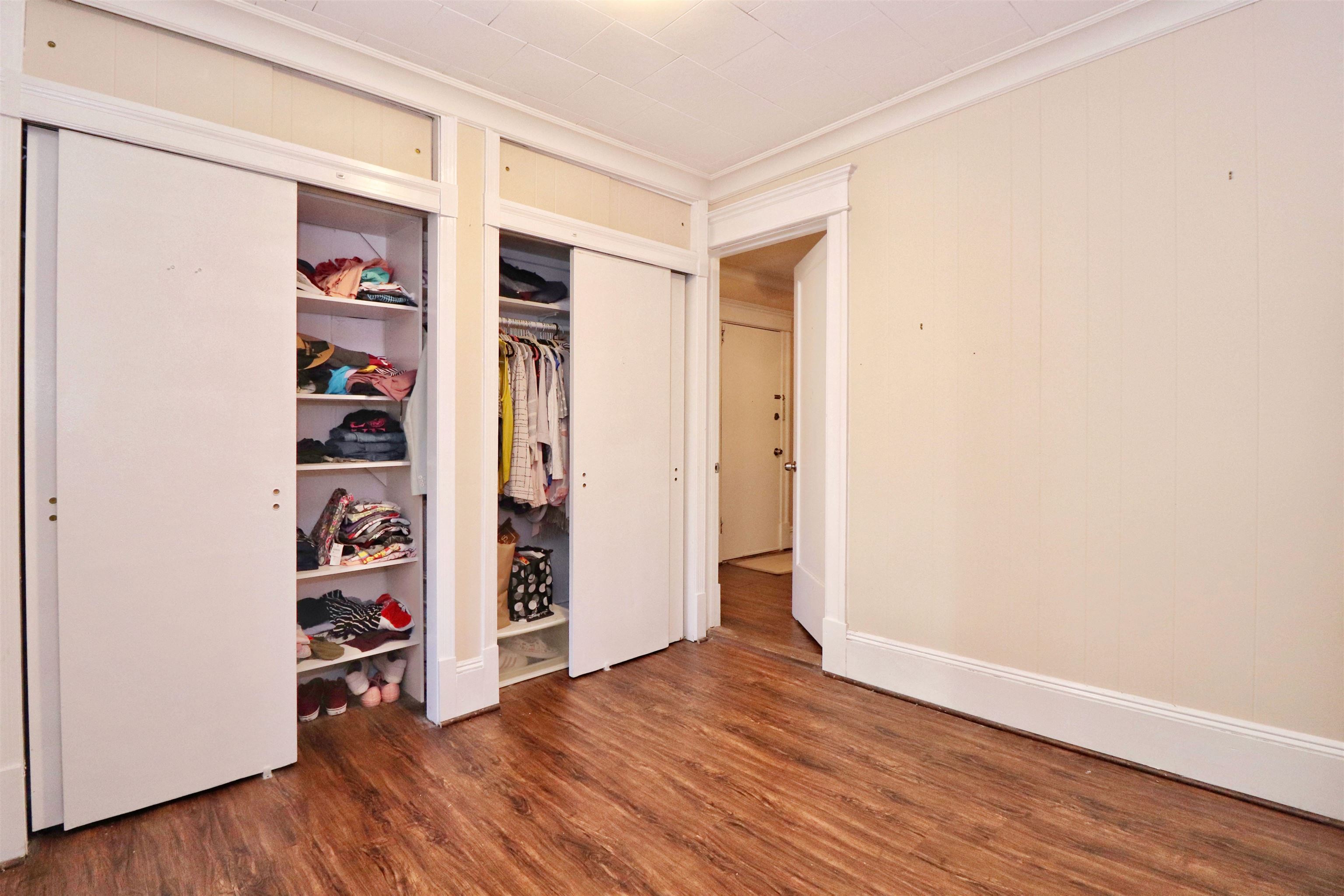 704 Washington Street, Unit 2 Hoboken, NJ 07030 - Photo 14 of 23 an empty room with walk in closet and wooden floor