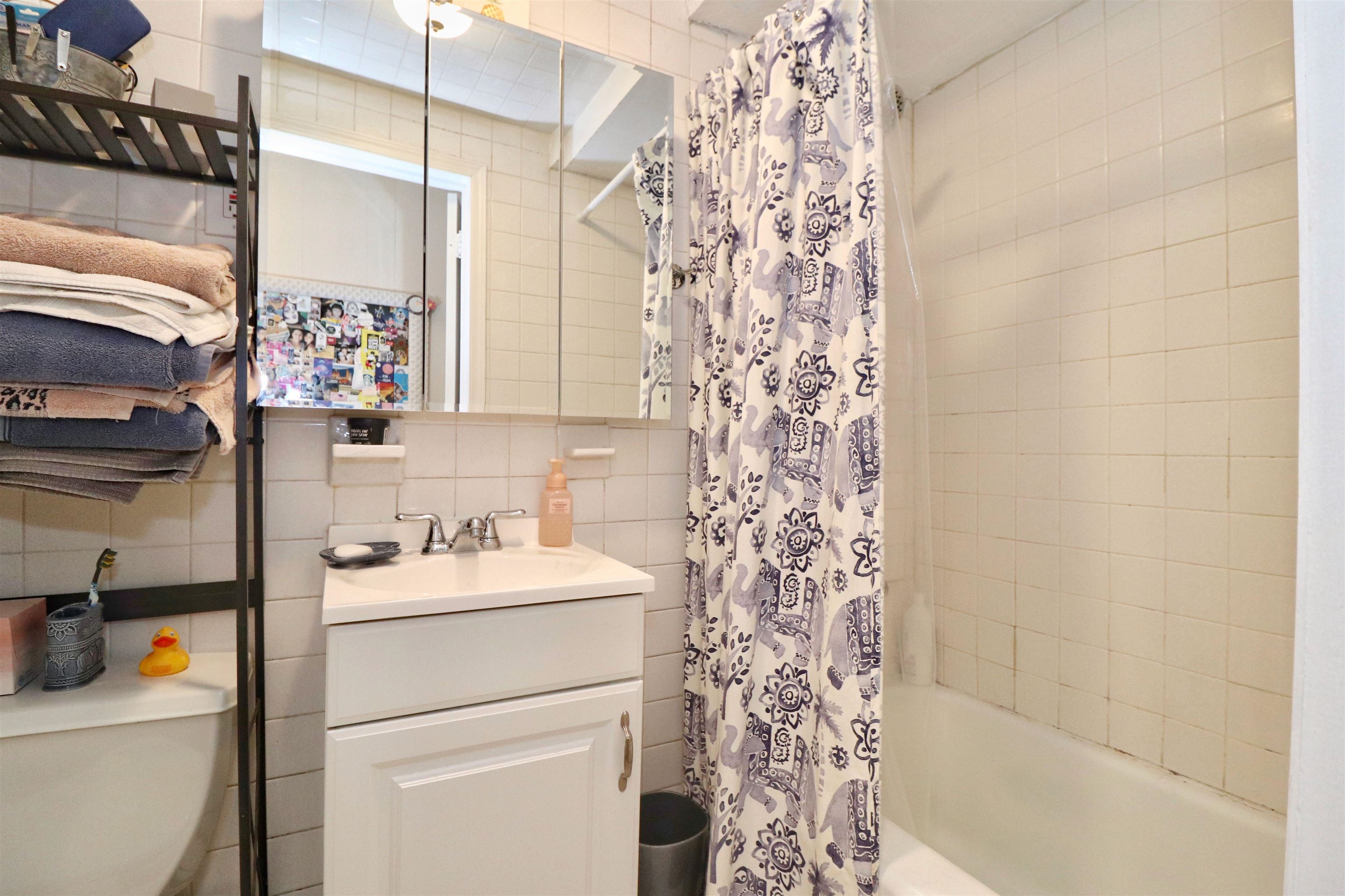 704 Washington Street, Unit 2 Hoboken, NJ 07030 - Photo 20 of 23 a bathroom with a sink toilet and shower