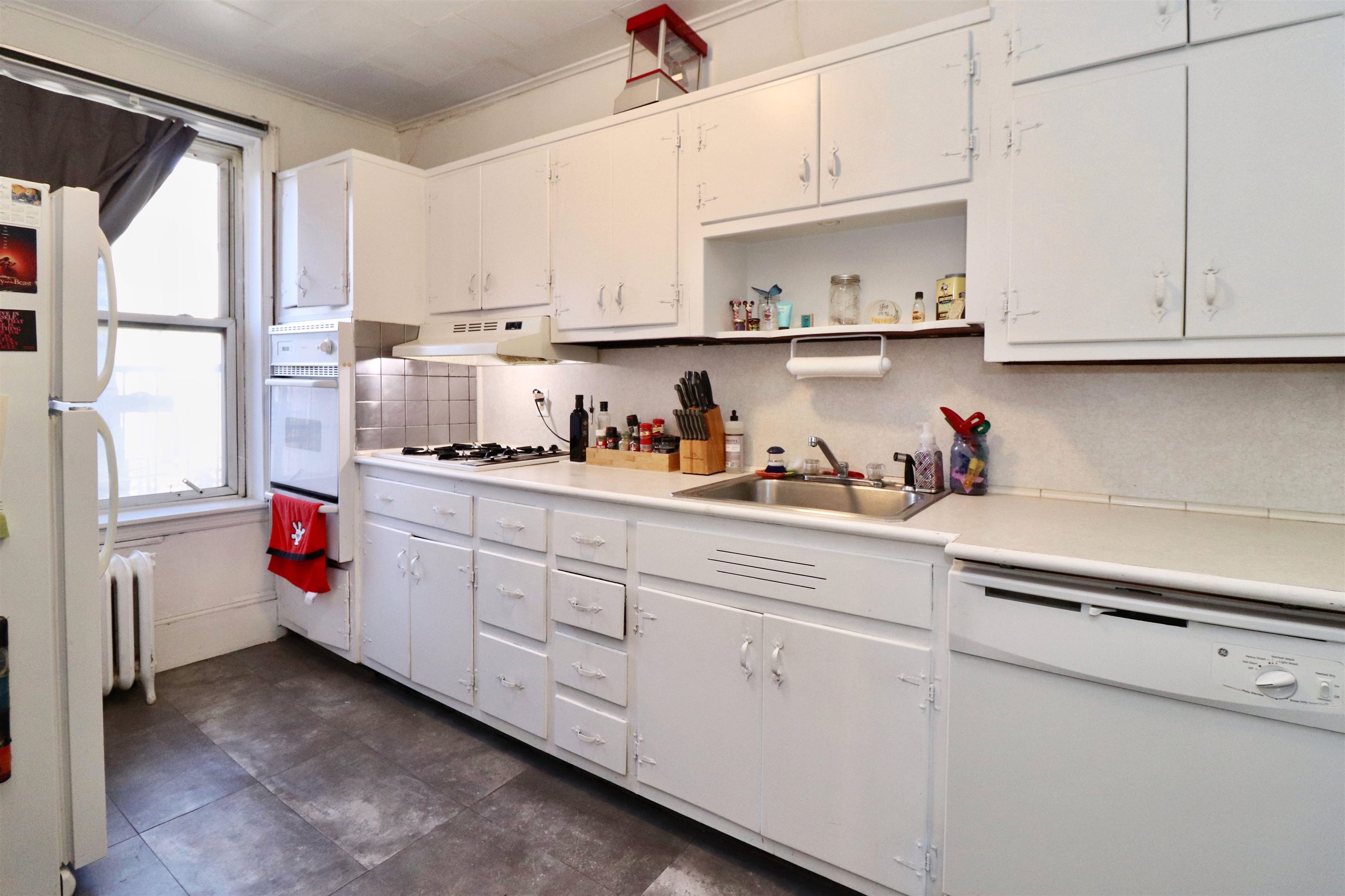 704 Washington Street, Unit 2 Hoboken, NJ 07030 - Photo 2 of 23 a kitchen with white cabinets and white appliances