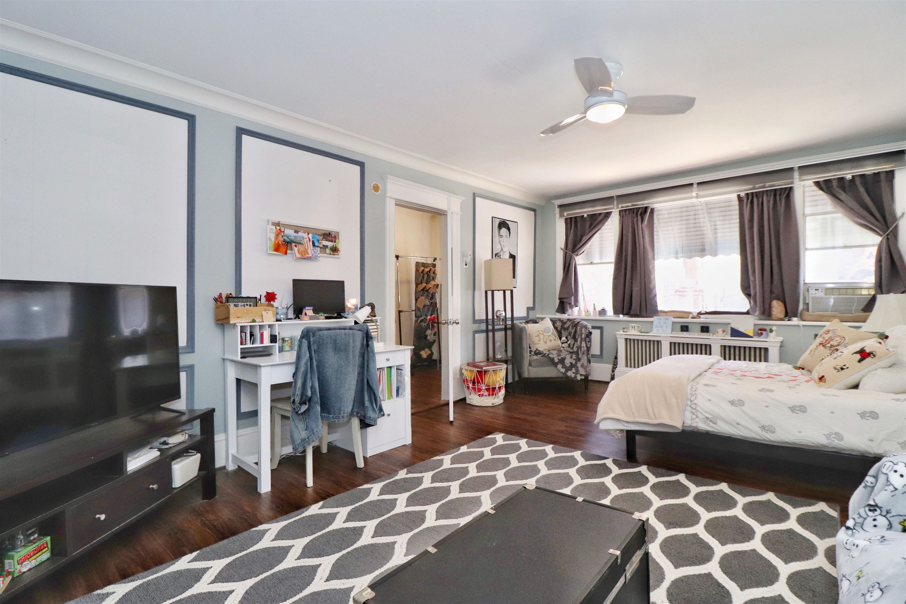 704 Washington Street, Unit 2 Hoboken, NJ 07030 - Photo 5 of 23 a bedroom with furniture and a flat screen tv