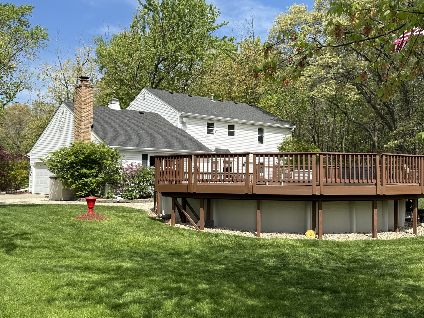1201 East Street Crete, IL 60417 - Photo 15 of 45 a view of a house with a deck and a yard with a large tree