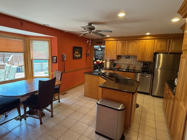 1201 East Street Crete, IL 60417 - Photo 18 of 45 a kitchen with stainless steel appliances granite countertop a refrigerator a sink dishwasher a dining table and chairs with wooden floor