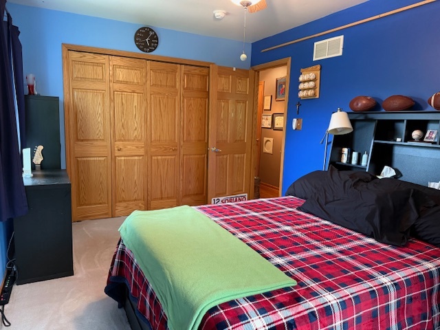 1201 East Street Crete, IL 60417 - Photo 35 of 45 a bedroom with a bed and a lamp on dresser