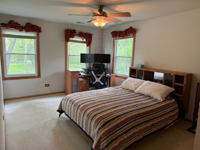 1201 East Street Crete, IL 60417 - Photo 37 of 45 a bedroom with a bed and a chandelier