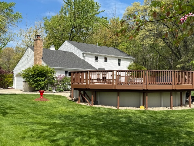 1201 East Street Crete, IL 60417 - Photo 7 of 45 a view of a house with a wooden deck and a yard