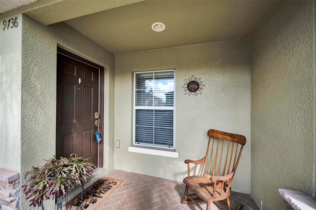 9736 Trumpet Vine Loop Trinity, FL 34655 - Photo 14 of 35 a view of a room that has a bed and a chair in it