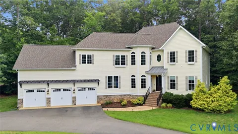 a front view of a house with a garden and plants