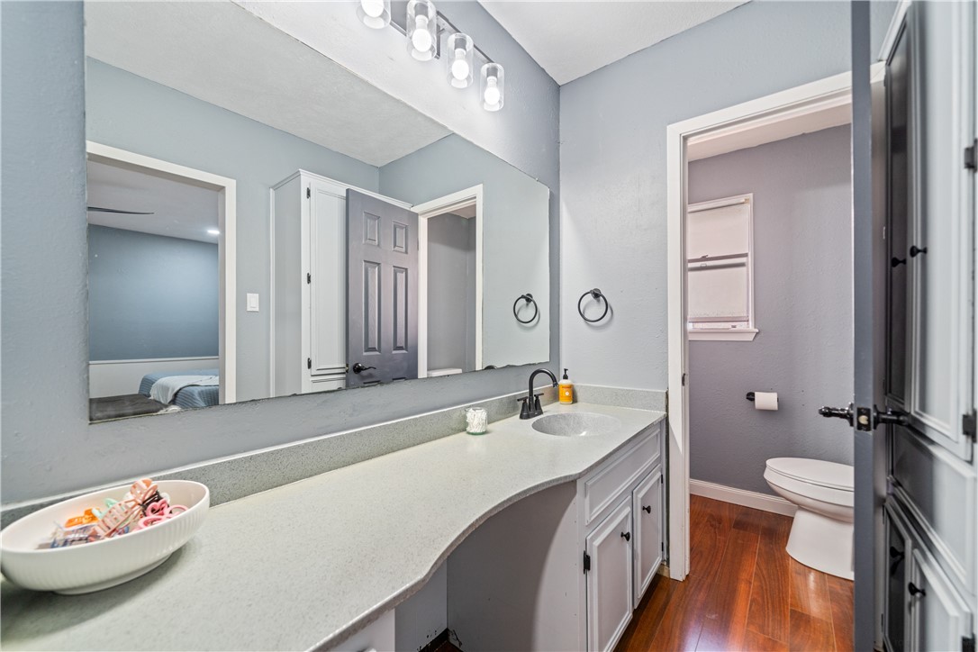 2217 Post Oak Drive Portland, TX 78374 - Photo 21 of 39 a bathroom with a sink a toilet and a mirror