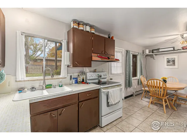 a kitchen with a sink cabinets and window