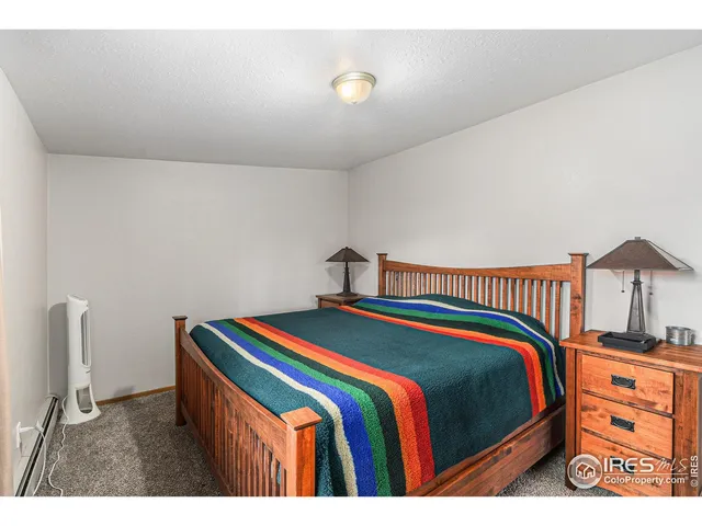 a bedroom with a bed and a night stand