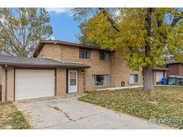 a house that has a tree in front of it