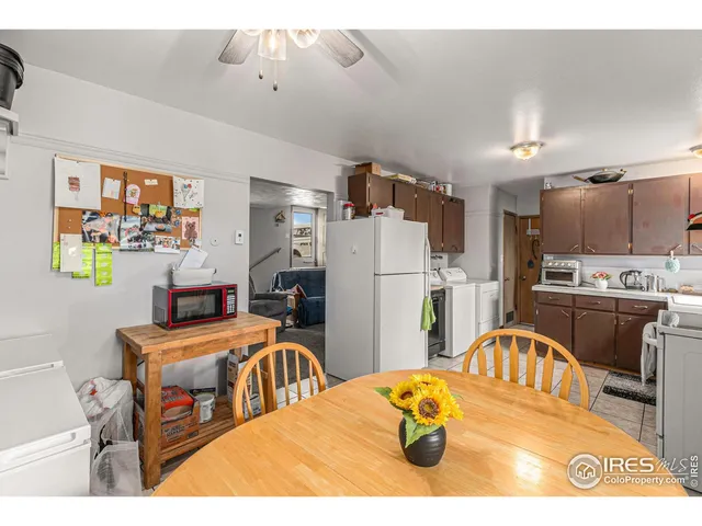 a kitchen with stainless steel appliances kitchen island granite countertop a refrigerator a stove a sink dishwasher and white countertops with wooden floor
