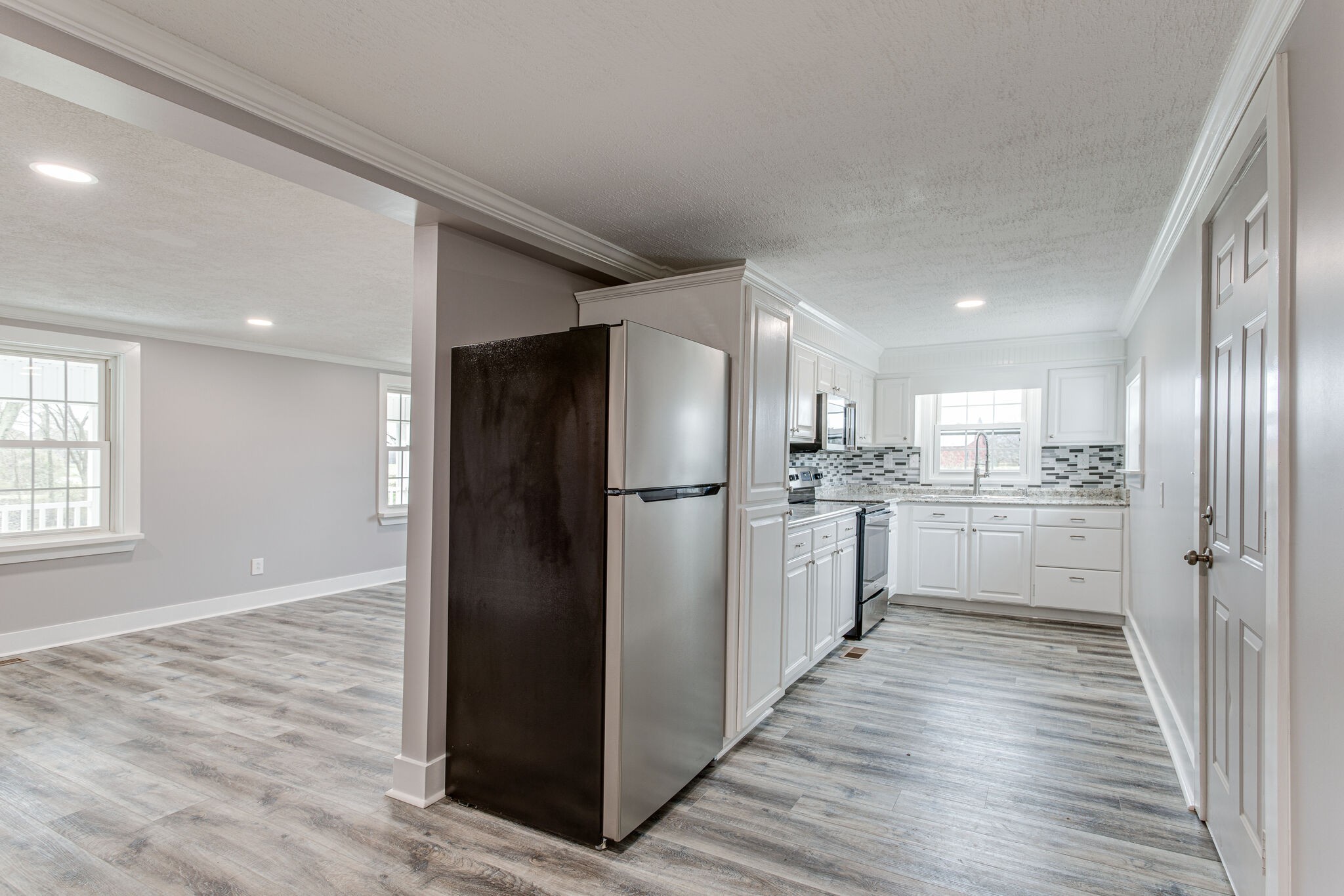 1466 Bible Crossing Road Winchester, TN 37398 - Photo 13 of 31 a kitchen with white cabinets and stainless steel appliances