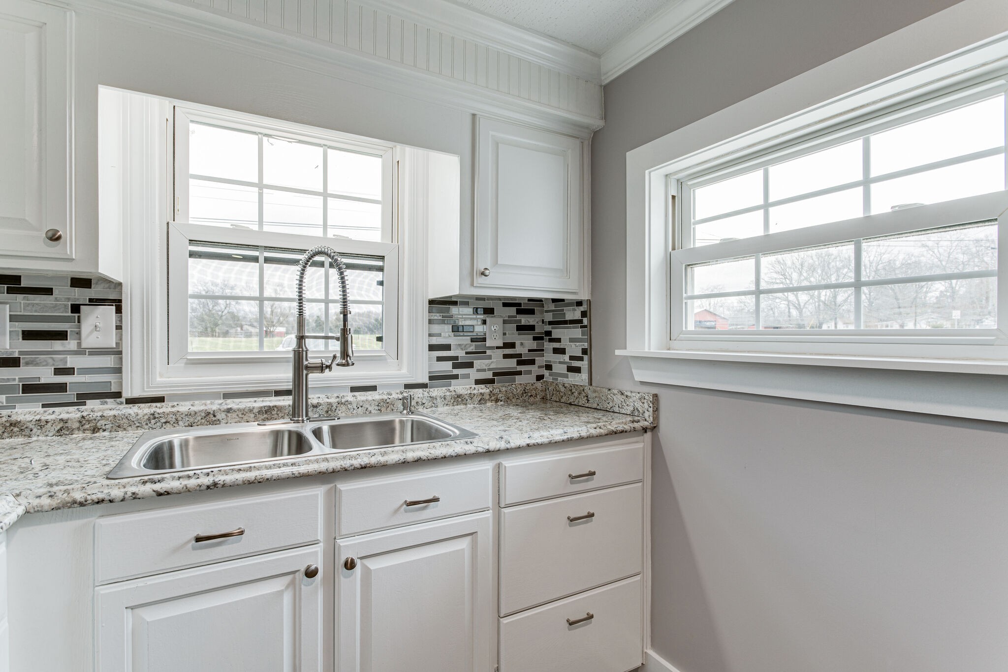 1466 Bible Crossing Road Winchester, TN 37398 - Photo 15 of 31 a kitchen with granite countertop a sink window and cabinets