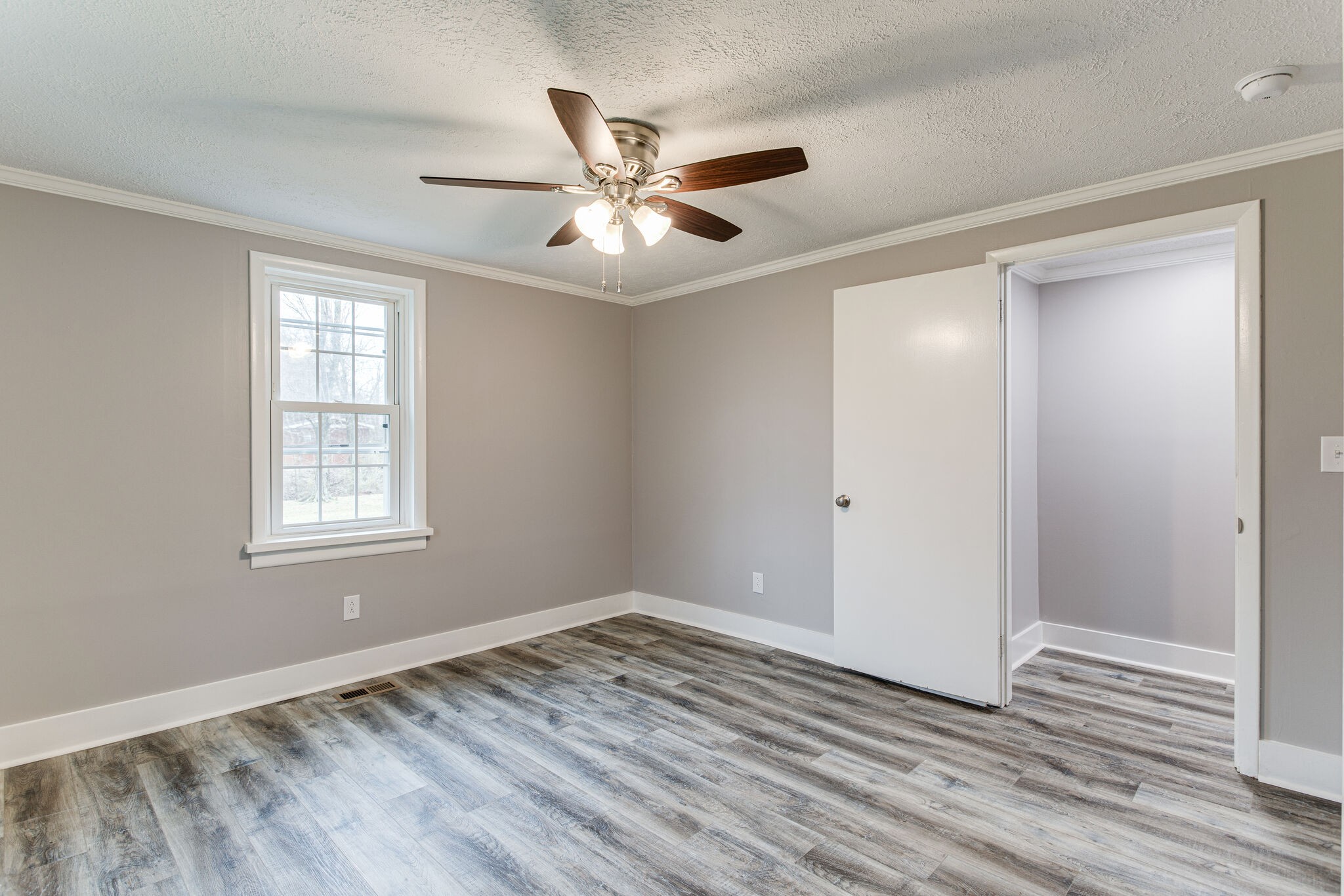 1466 Bible Crossing Road Winchester, TN 37398 - Photo 21 of 31 a view of an empty room with wooden floor and a window