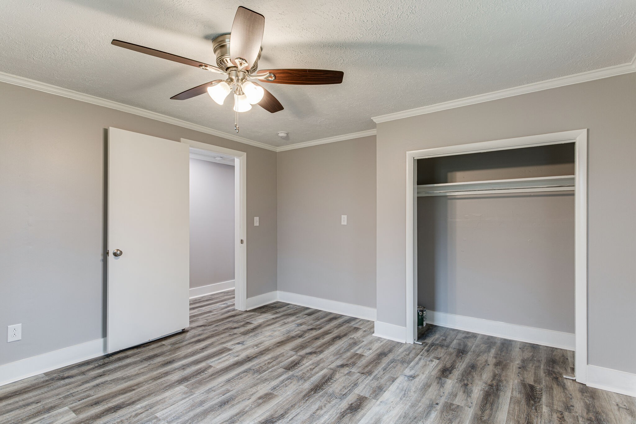 1466 Bible Crossing Road Winchester, TN 37398 - Photo 22 of 31 a view of an empty room with wooden floor and a ceiling fan