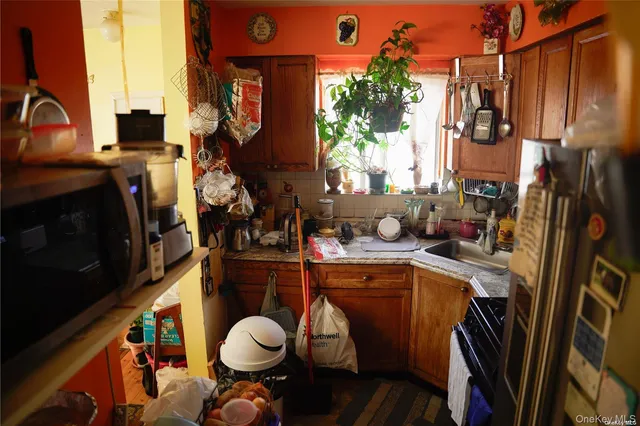 a kitchen with a sink a stove and a refrigerator